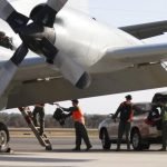 RAAF AP-3C Orion crew members unload equipment after returning from a search for Malaysian Airlines flight MH370 over the Indian Ocean near Perth