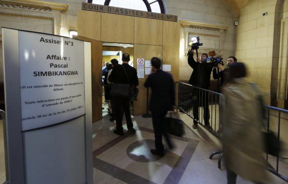 Journalists arrive for the sentence of the trial of former Rwandan army captain Simbikangwa at a Paris court