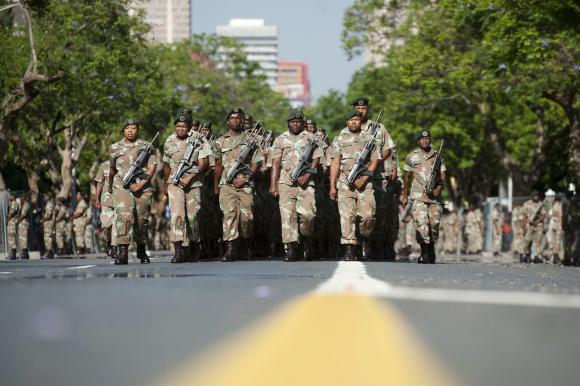 SANDF soldiers parade on the streets near the Union Buildings, where the body of Nelson Mandela will lie in state, in Pretoria