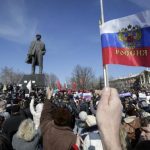 File photo of pro-Russian demonstrators taking part in a rally in front of a statue of Soviet state founder Vladimir Lenin in Donetsk