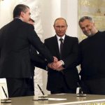 Russian President Putin, Crimea's PM Aksyonov, Crimean parliamentary speaker Konstantinov and Sevastopol Mayor Chaliy shake hands after a signing ceremony in Moscow