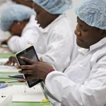 Workers assemble Android-based tablets from imported components at the Surtab factory in Port-au-Prince