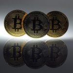 Mock Bitcoins are displayed on a table in an illustration picture taken in Berlin