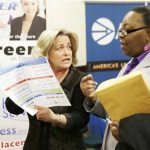 recruiter Valera Kulow, left, speaks with job seeker Monic Spencer