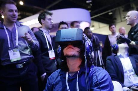 show attendees play a video game wearing Oculus Rift virtual reality headsets