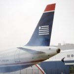 A US Airways plane emits exhaust at Philadelphia International Airport