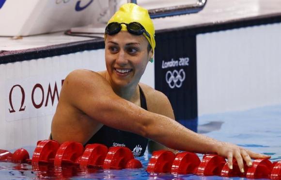 Australia's Stephanie Rice smiles after finishing in third place in heat 5 of the women's 200m individual medley event at the London 2012 Olympic Games at the Aquatics Centre