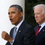 U.S. President Barack Obama stands next to Vice President Joseph Biden while speaking about the enrolment numbers of the Affordable Care Act at the White House in Washington
