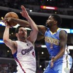 Los Angeles Clippers guard J.J. Redick, left, looks to shoot as Denver Nuggets guard Aaron Brooks