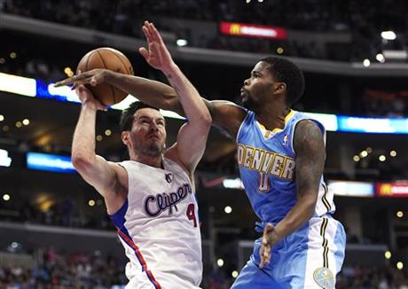 Los Angeles Clippers guard J.J. Redick, left, looks to shoot as Denver Nuggets guard Aaron Brooks