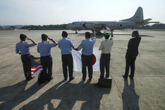 Miyagawa, Japanese ambassador to Malaysia, Jufuku, commander of Japan's Maritime Self-Defense Force and Royal Malaysian Air Force members wave to Japan Maritime Self-Defense Force P3C crew departing to Pearce Airbase at Subang Airbase