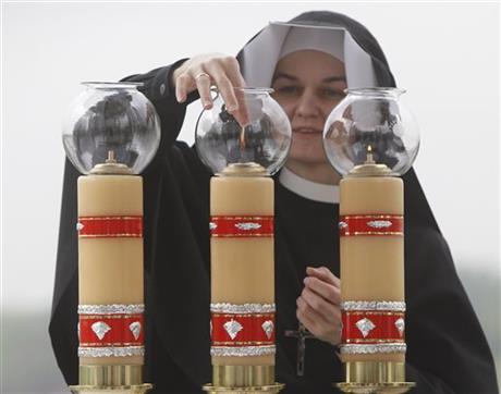 Sister Sancja readies the altar in God’s Mercy sanctuary in Krakow