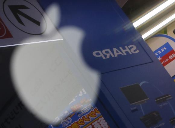 File photo of Sharp Corp logo reflected on Apple Inc's MacBook Pro at an electronics store in Tokyo