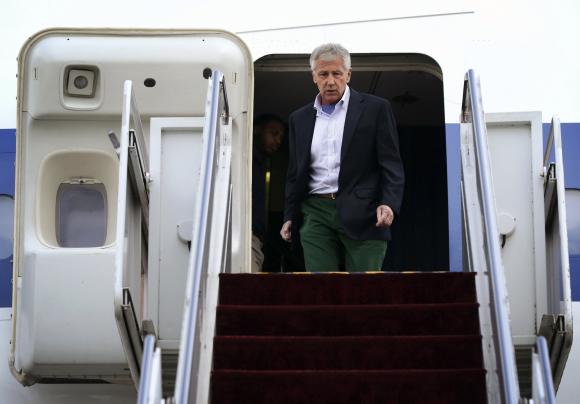 U.S. Defense Secretary Chuck Hagel walks off an aircraft upon his arrival at Yokota Air Force Base in Fussa