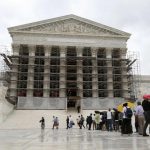 Visitors to the Supreme Court are pictured jn the rain in Washington