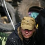 Pro-Russian protester seats at barricades at the police headquarters in Slaviansk