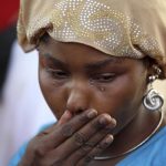 Protester cries during a sit-in rally for the abducted schoolgirls, at the Unity Fountain in Abuja