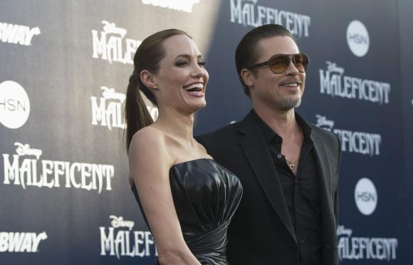 Cast member Jolie and actor Pitt pose at the premiere of "Maleficent" at El Capitan theatre in Hollywood