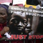 A woman holds a sign during a protest demanding the release of abducted secondary school girls from the remote village of Chibok, in Lagos