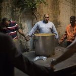 Brazil, Pastor Celio Ricardo, center, prays with members of the God's Love