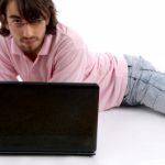 Lying Young Man With Laptop - by imagerymajestic