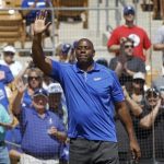 Los Angeles Dodgers co-owner Earvin Magic Johnson acknowledges the crowd before MLB Cactus League spring training baseball game against the Cincinnati Reds in Glendale