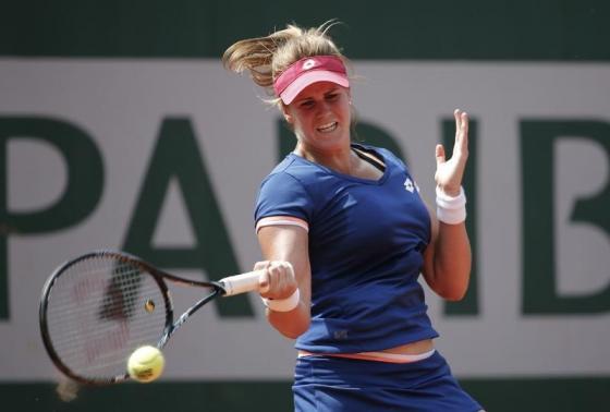 Maria-Teresa Torro-Flor of Spain returns a forehand to Simona Halep of Romania during their women's singles match at the French Open tennis tournament at the Roland Garros stadium in Paris