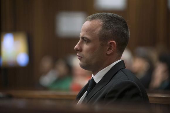 Olympic and Paralympic track star Oscar Pistorius sits in the dock in the North Gauteng High Court in Pretoria