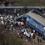 People gather around a passenger train