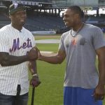 Rapper 50 Cent talks with New York Mets' Curtis Granderson, right,