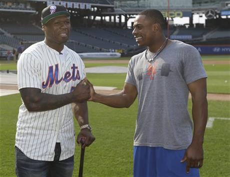 Rapper 50 Cent talks with New York Mets' Curtis Granderson, right,
