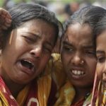 Relatives of victims killed in ethnic violence mourn