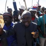 Striking platinum miners sing and dance during a rally near Lonmin's Marikana mine