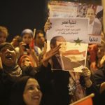 Supporters of Sisi hold a poster of him as they celebrate at Tahrir square in Cairo
