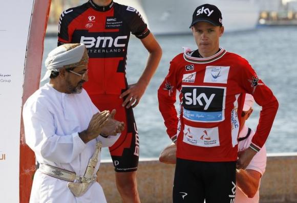 Team Sky rider Froome puts on the leader's red jersey after winning the Tour of Oman cycling race before the podium ceremony in Muscat