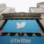 A sign displays the Twitter logo on the front of the New York Stock Exchange ahead of the company's IPO in New York