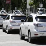a row of Google self-driving cars