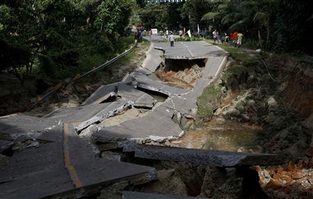 View of portion of damaged highway in Getafe, Bohol a day after an earthquake hit central Philippines