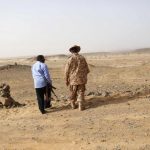 A Libyan soldier and a member of a security unit patrol the desert border between Libya and Algeria