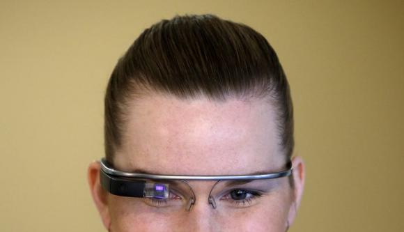 A woman wears Google glasses after a media presentation of a Google apartment in Prague