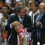 Atletico's David Villa, is patted on the head by UEFA president Michel Platini