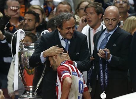 Atletico's David Villa, is patted on the head by UEFA president Michel Platini