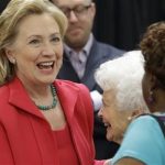 Former Secretary of State Hillary Clinton, left, greets Mabel Harris-Webb, 95, center
