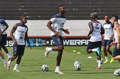 France's Paul Pogba, center, warms up during a training session at Santa Cruz stadium