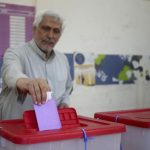 A man casts his vote at a polling station during a parliamentary election in Benghazi