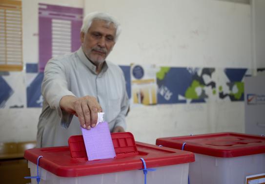 A man casts his vote at a polling station during a parliamentary election in Benghazi