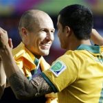 Netherlands' Arjen Robben, left, hugs Australia's Tim Cahill