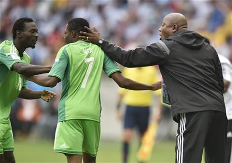 Nigeria's coach Stephen Keshi, right, and teammate Juwon Oshaniwa, left, congratulate Ahmed Musa