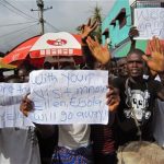 People protest outside a hospital as Liberia President Ellen Johnson Sirleaf