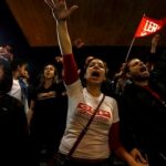Protesters shout slogans in front of closed Ana Rosa subway station